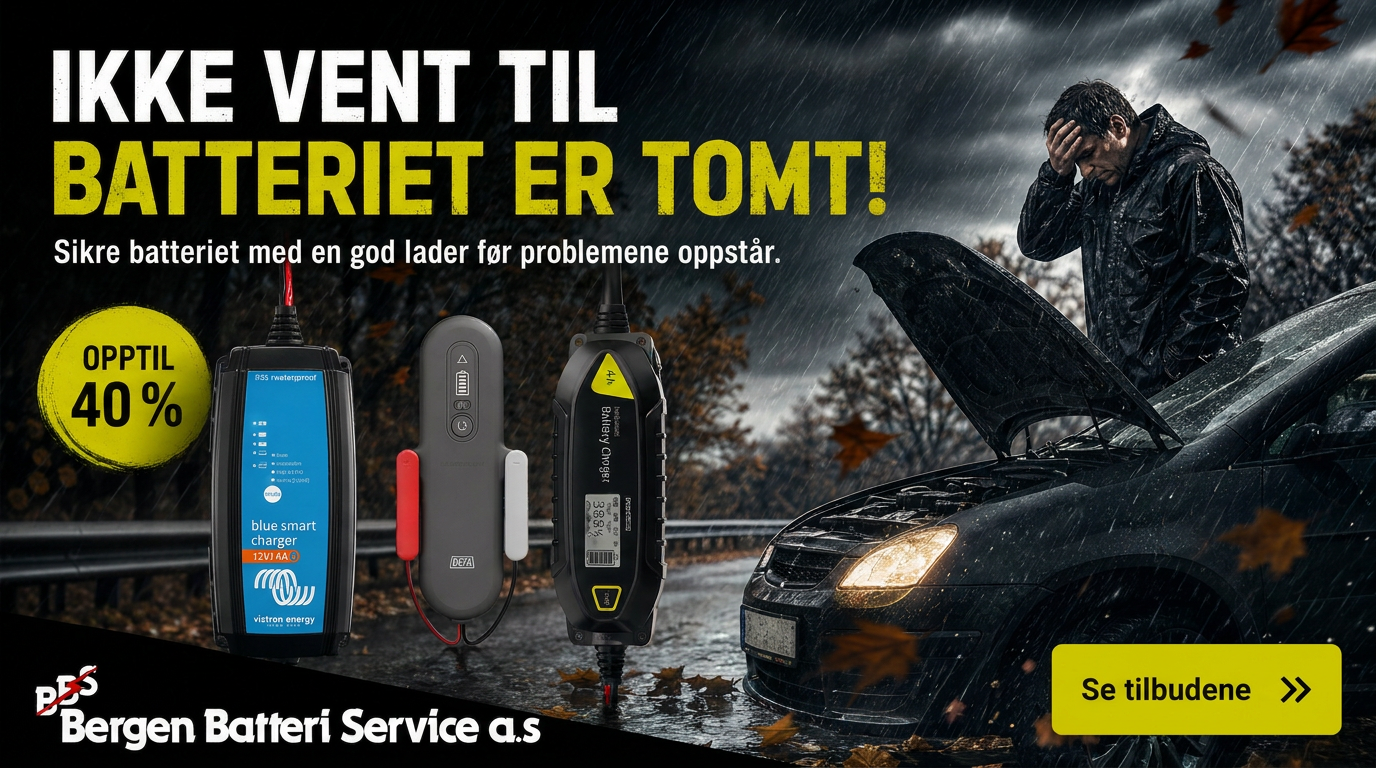 Utvalg av batteriladere på et verkstedbenk, med en ingeniør som undersøker en av laderne